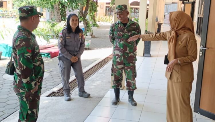 Babinsa Kratonan ngobrol santai dengan kepala sekolah di sela kegiatan belajar mengajar